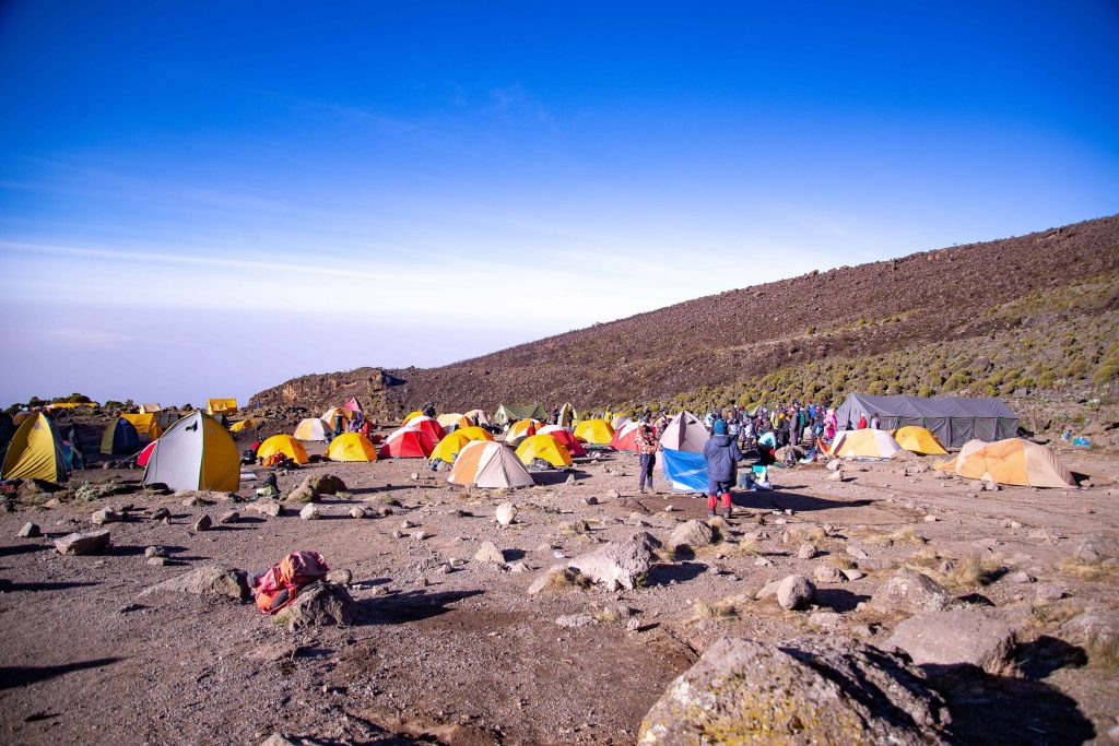 Crowded tent camp above cloud line on Mount Kilimanjaro