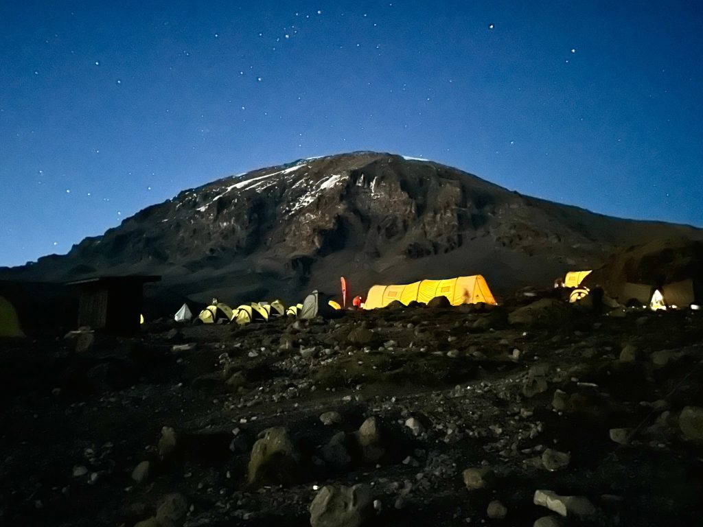 Glowing mess tent under stars at camp on Mount Kilimanjaro