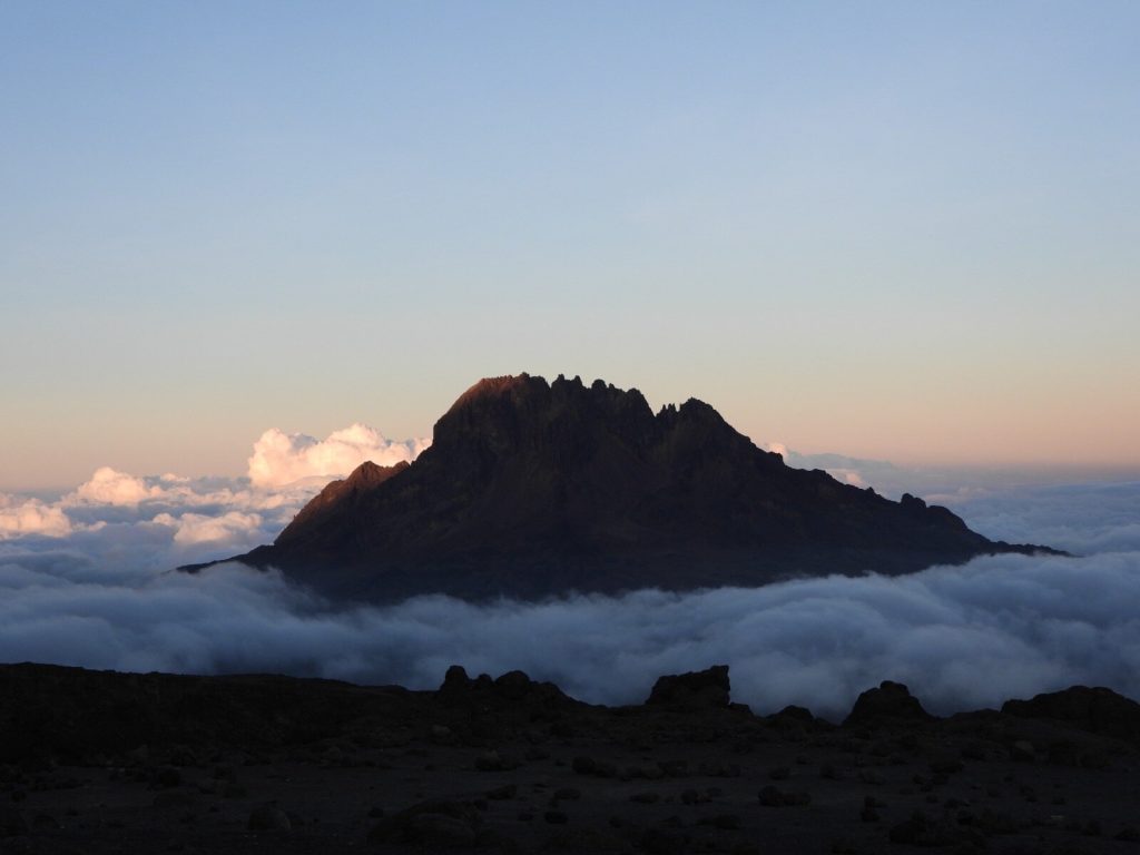 Mawenzi, the jagged dark second peak of Kilimanjaro, above a sea of cloud at dawn