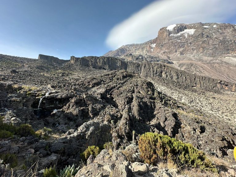Lava ridge and waterfall below summit dome on Mount Kilimanjaro