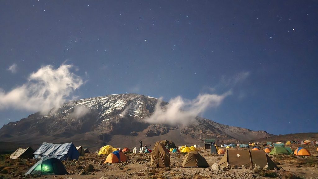 Moonlit tent camp under stars below kibo on Mount Kilimanjaro