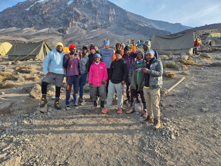 Porters and guides group photo at camp on Mount Kilimanjaro